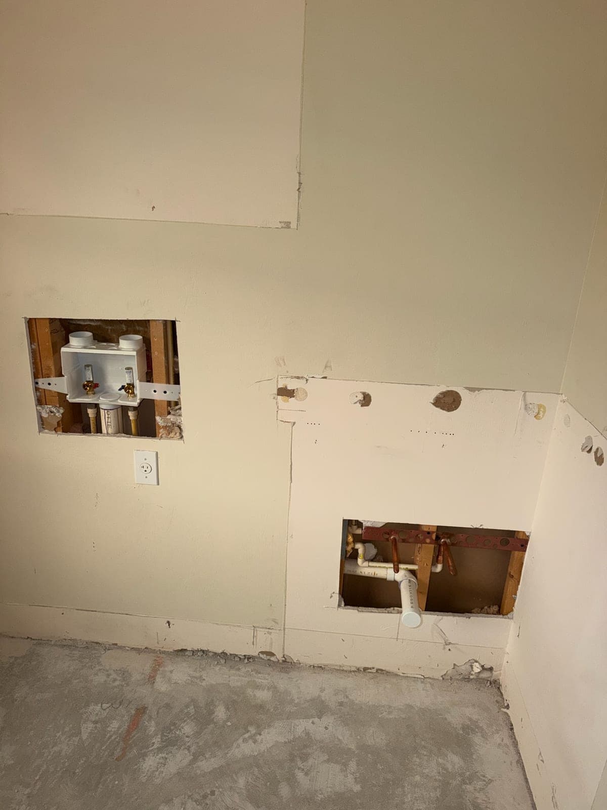 Recessed laundry outlet box with hot and cold valves set into an opened wall